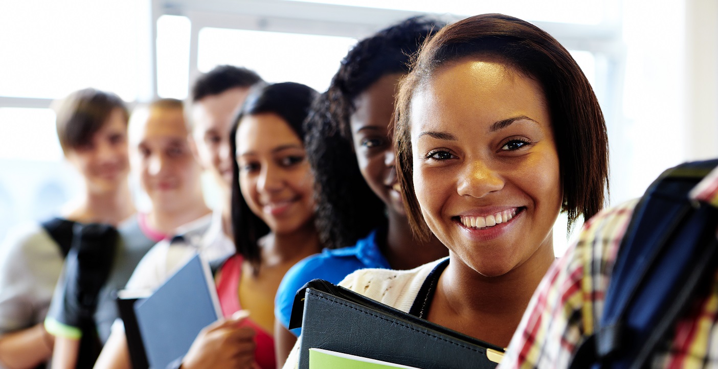Smiling students holding books
